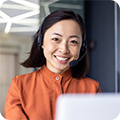 A call center worker smiles at the camera. 